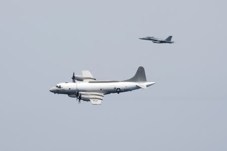 FILE PHOTO: A U.S. Navy EP-3E Aries signals reconnaissance aircraft, escorted by an EA-18G Growler electronic warfare aircraft, performs a flyby over aircraft carrier USS Harry S. Truman in the Arabian Gulf April 24, 2016. U.S. Navy/Mass Communication Specialist 3rd Class Bobby J Siens/Handout/File Photo via REUTERS