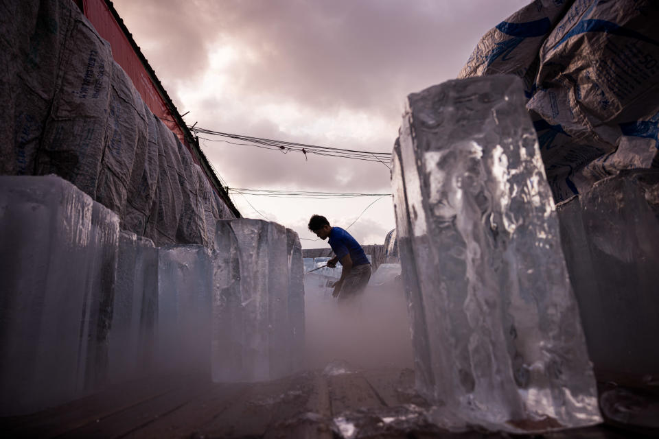 A man unloads blocks of ice from a truck during high temperatures in Bangkok, Thailand, on Sunday, April 28, 2024.  / Credit: Andre Malerba/Bloomberg via Getty Images