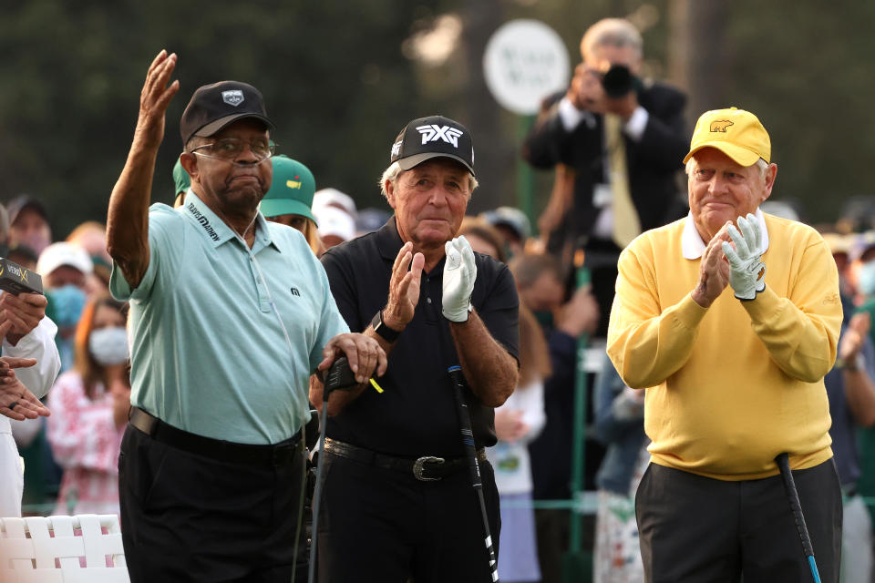 Honorary Starter Lee Elder of the United States (pictured left), waves to the patrons as he is introduced and honorary starter and Masters champion Gary Player (pictured midle) and honorary starter and Masters champion Jack Nicklaus (pictured right) applaud.