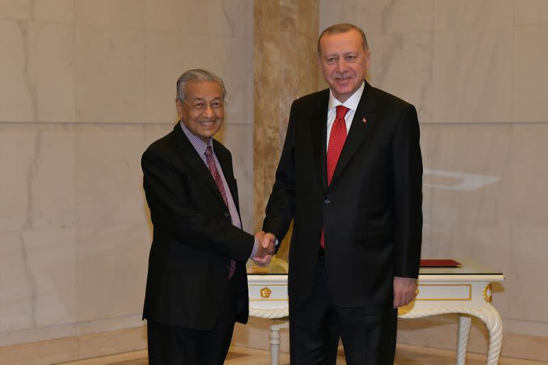 Malaysia's Prime Minister Mahathir Mohamad shakes hands with Turkey's President Recep Tayyip Erdogan at Prime Minister Office in Putrajaya