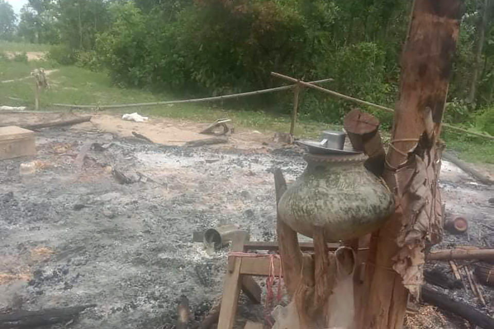 In this image provided by Myanmar Witness, which is undated and unverified but matches AP reporting and eye-witness testimony, a burned structure with household goods is marked out near where bodies were found burned outside Taung Pauk village in Kani township in the northwestern Sagaing region of Myanmar following reports of a massacre of 11 people on July 28, 2021. (Myanmar Witness via AP)