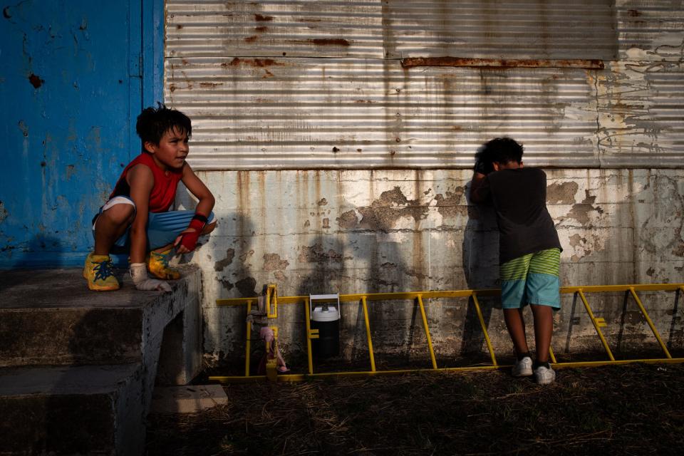 Leon Perez, left, and Fernando Gaeta, 8, take a breather after running laps at Gollihar Neighborhood Boxing Center on July 26, 2023, in Corpus Christi, Texas. The gym has more than 60 boxers registered through USA Boxing, Head Coach Richard Rodriguez said.