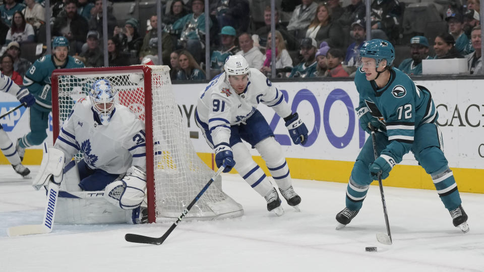 San Jose Sharks left wing William Eklund (72) skates with the puck against Toronto Maple Leafs center John Tavares (91) and goaltender Martin Jones (31) during the first period of an NHL hockey game in San Jose, Calif., Saturday, Jan. 6, 2024. (AP Photo/Jeff Chiu)