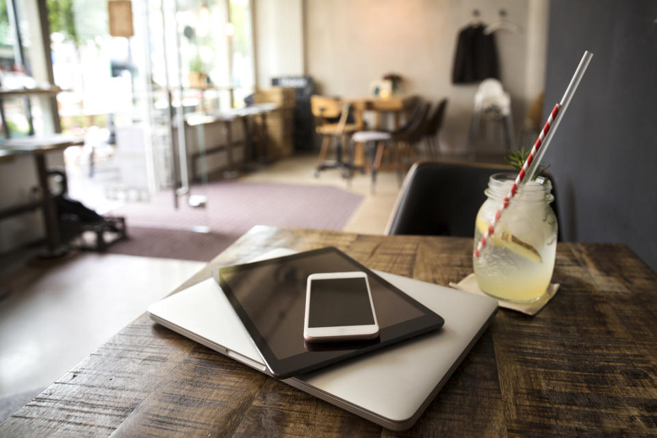 Electronics on a cafe table.