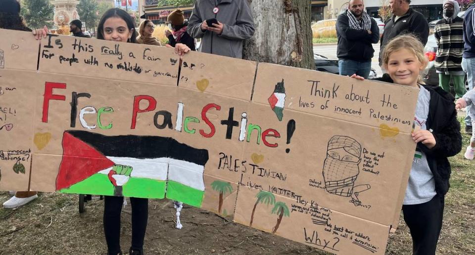 Yasmeen’s daughter and her friend, hold a sign they created to participate in the Palestinian Rally. Samantha Latson