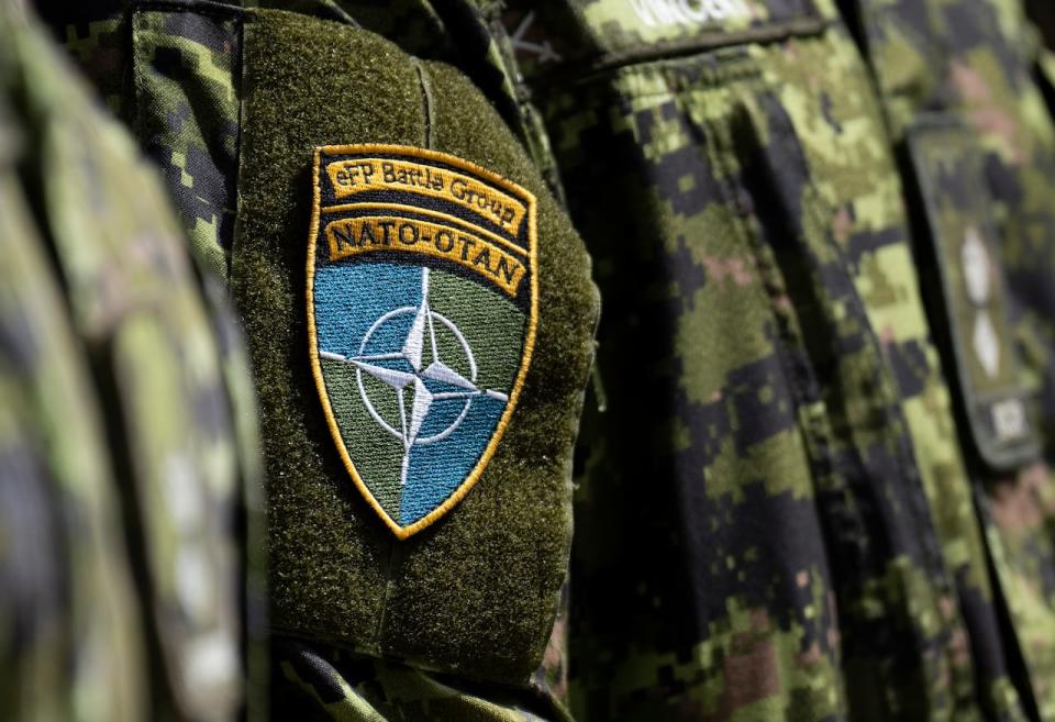 A Canadian soldier wears the NATO Battle Group patch as he listens to Prime Minister Justin Trudeau speak at the Adazi Military base, Monday, July 10, 2023 in Adazi, Latvia. 