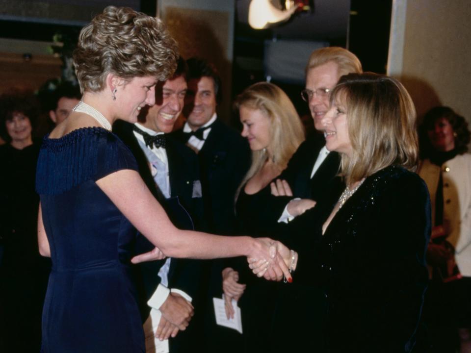 Princess Diana and Barbra Streisand are photographed shaking hands