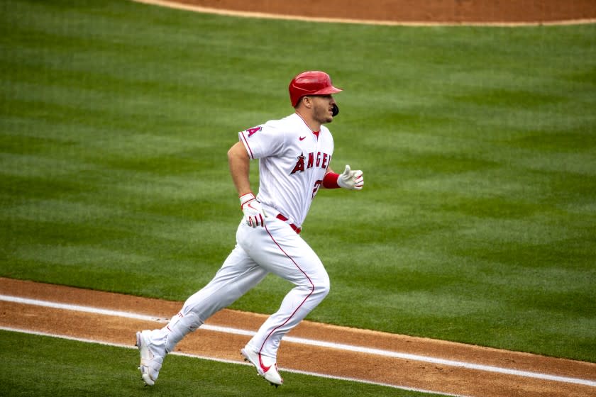 ANAHEIM, CA - APRIL 21, 2021: Los Angeles Angels center fielder Mike Trout (27) runs the bases after hitting the first pitch for a homer against Texas Rangers starting pitcher Mike Foltynewicz (20) in the 1st inning at Angel Stadium on April 21, 2021 in Santa Ana California.(Gina Ferazzi / Los Angeles Times)