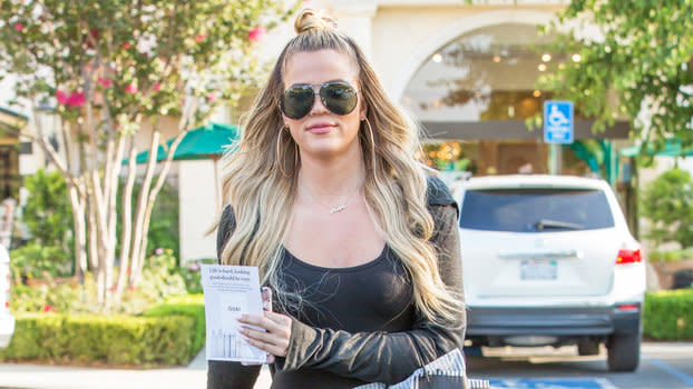 Khloe Kardashian displays her curves in a black bodysuit paired with  thigh-high boots as she leaves a studio in Los Angeles-230523_9