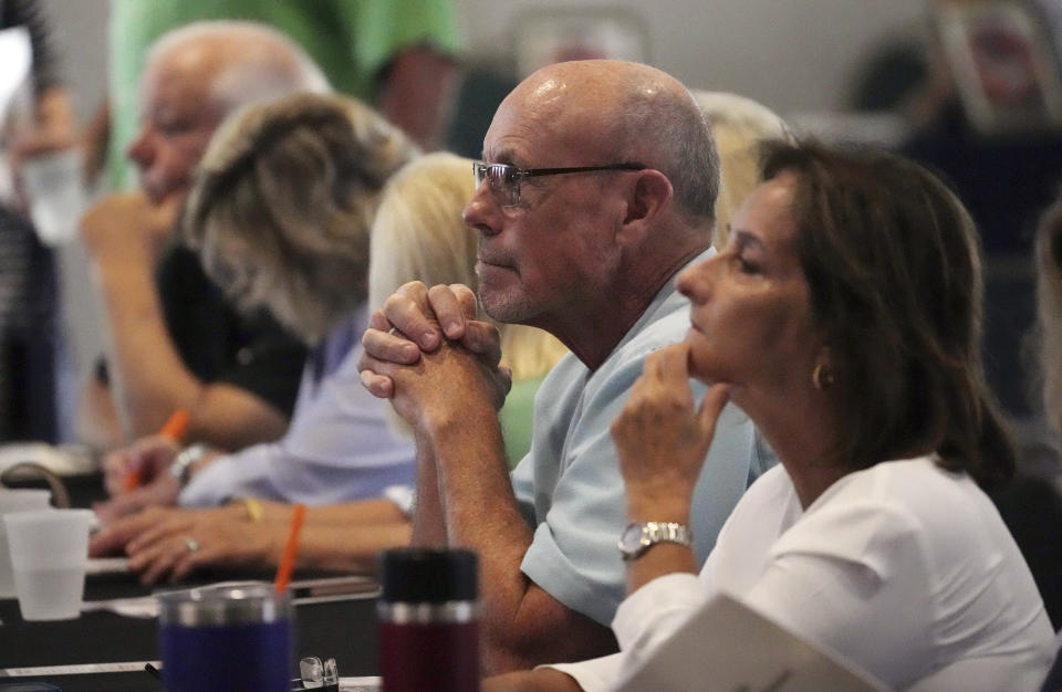 People attend a conference on conspiracy theories about voting machines and discredited claims about the 2020 presidential election at a hotel in West Palm Beach, Fla., Saturday, Sept. 10, 2022. The event featured Republicans running for statewide offices that oversee elections in some of the most important battleground states. (AP Photo/Jim Rassol)