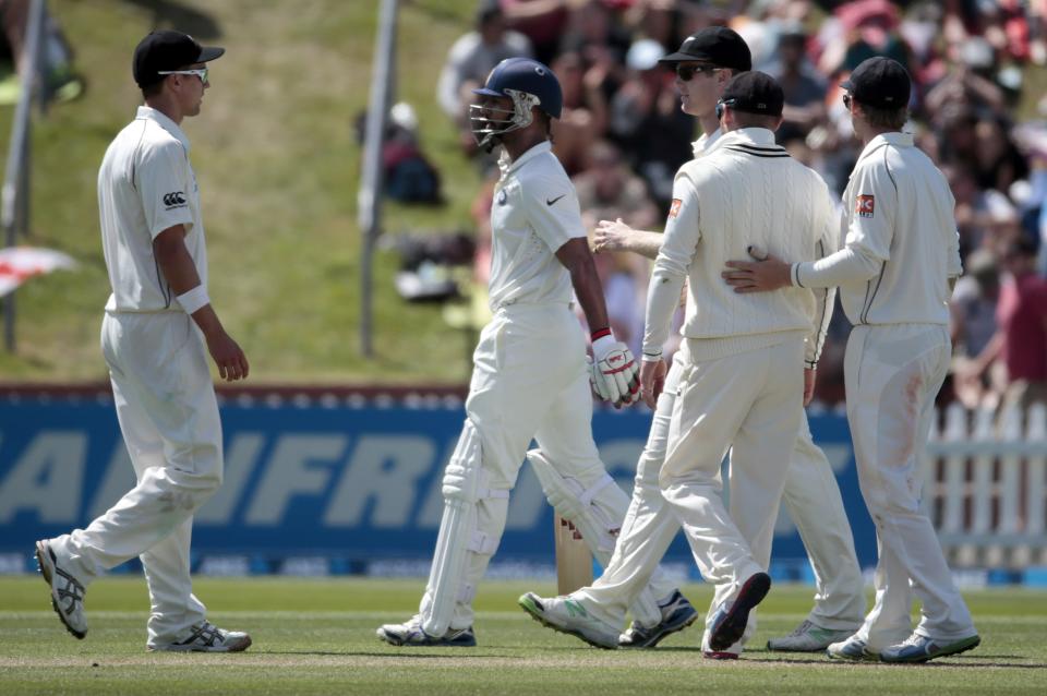 New Zealand's players celebrate the dismissal of India's Shikhar Dhawan (2nd L) for 98 during the first innings on day two of the second international test cricket match at the Basin Reserve in Wellington, February 15, 2014. REUTERS/Anthony Phelps (NEW ZEALAND - Tags: SPORT CRICKET)