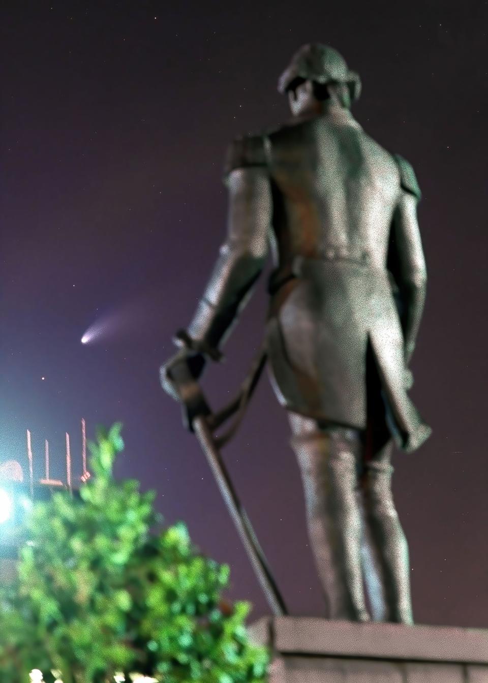 Bright enough for city dwellers,  Comet Hale-Bopp is obvious as it hangs in a brightly lighted downtown Fayetteville sky over the statue of Marquis de Lafayette in March 1997.