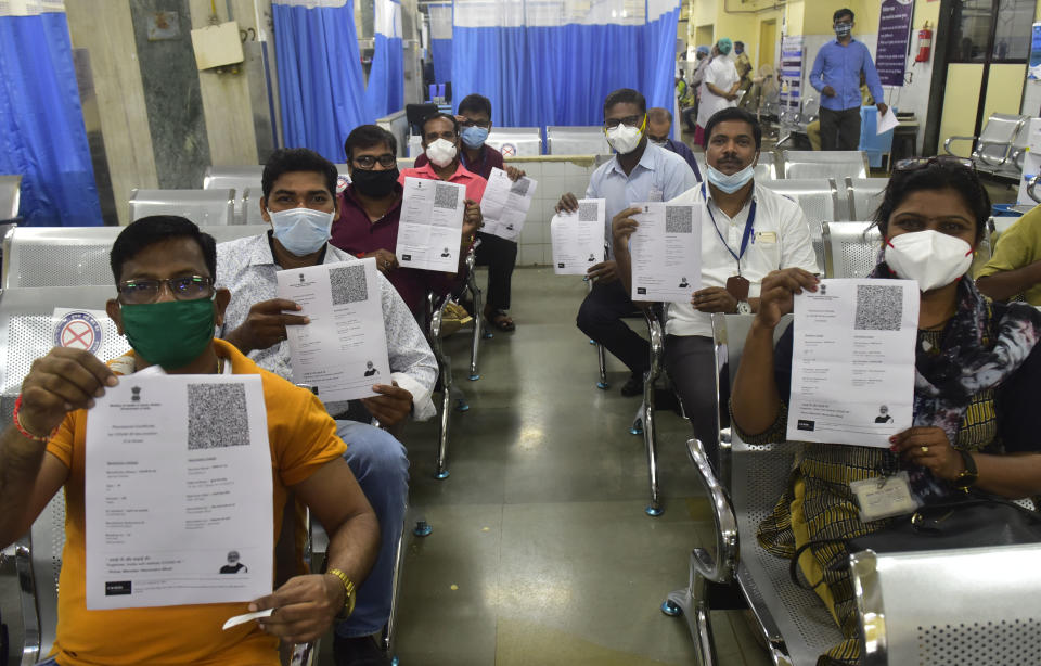 MUMBAI, INDIA  JANUARY 19: BMC medical staff Aruna Chavan(R) show her Provisional Certificate for COVID19 vaccination (1st dose) along with other vaccine beneficiary in a observation room at KEM Hospital, Parel on January 19, 2021 in Mumbai, India. India launched one of the worlds largest coronavirus vaccination drives on Saturday, setting in motion a complex deployment plan aimed at stemming the wide spread of infections across a nation of more than 1.3 billion people. (Photo by Anshuman Poyrekar/Hindustan Times via Getty Images)