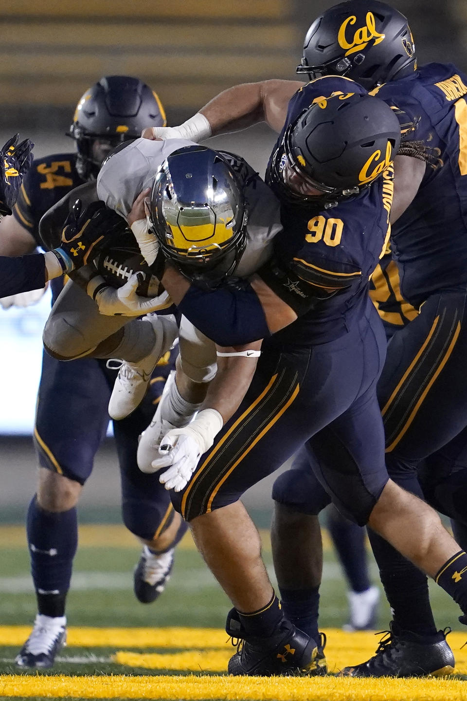 FILE - California defensive lineman Brett Johnson (90) tackles Oregon running back CJ Verdell during the first half of an NCAA college football game in Berkeley, Calif., Saturday, Dec. 5, 2020. When California opens the season at North Texas on Saturday, Golden Bears defensive lineman Brett Johnson may need a minute to soak in the moment. After missing two full seasons to deal with grueling injuries, Johnson is set to play a game for the first time in 1,001 days since a win over Oregon in an empty stadium on Dec. 5, 2020.(AP Photo/Jeff Chiu, File)