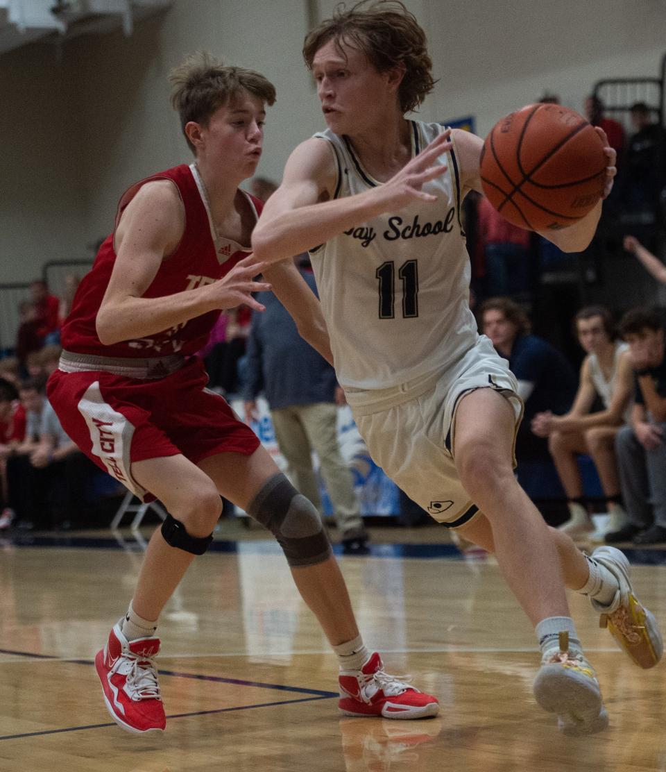 Evansville Day School’s Kane Wilsey (11) drives the ball as he’s pursued by Tell City’s Talon Jennings (11) as the Evansville Day School Eagles play the Tell City Marksmen at Evansville Day School in Evansville, Ind., Friday evening, Dec. 9, 2022. 