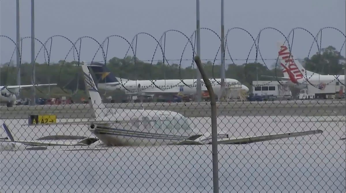 Partially-submerged small planes at Cairns Airport in Cairns, Australia Monday (AP)