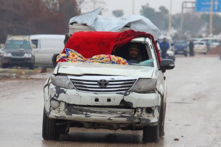 A man drives a vehicle with a blanket used instead of a broken windshield at insurgent-held al-Rashideen in the province of Aleppo, Syria December 22, 2016. REUTERS/Ammar Abdullah
