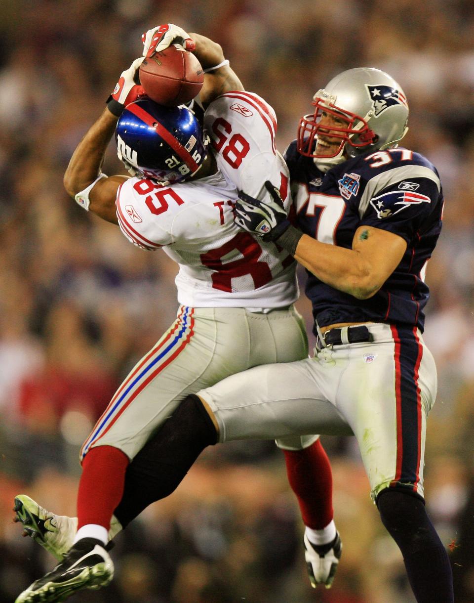 Giants player David Tyree makes a catch on their game-winning drive while tackled by Patriots safety Rodney Harrison in the fourth quarter during Super Bowl XLII at University of Phoenix Stadium in Glendale on Feb. 3, 2008.