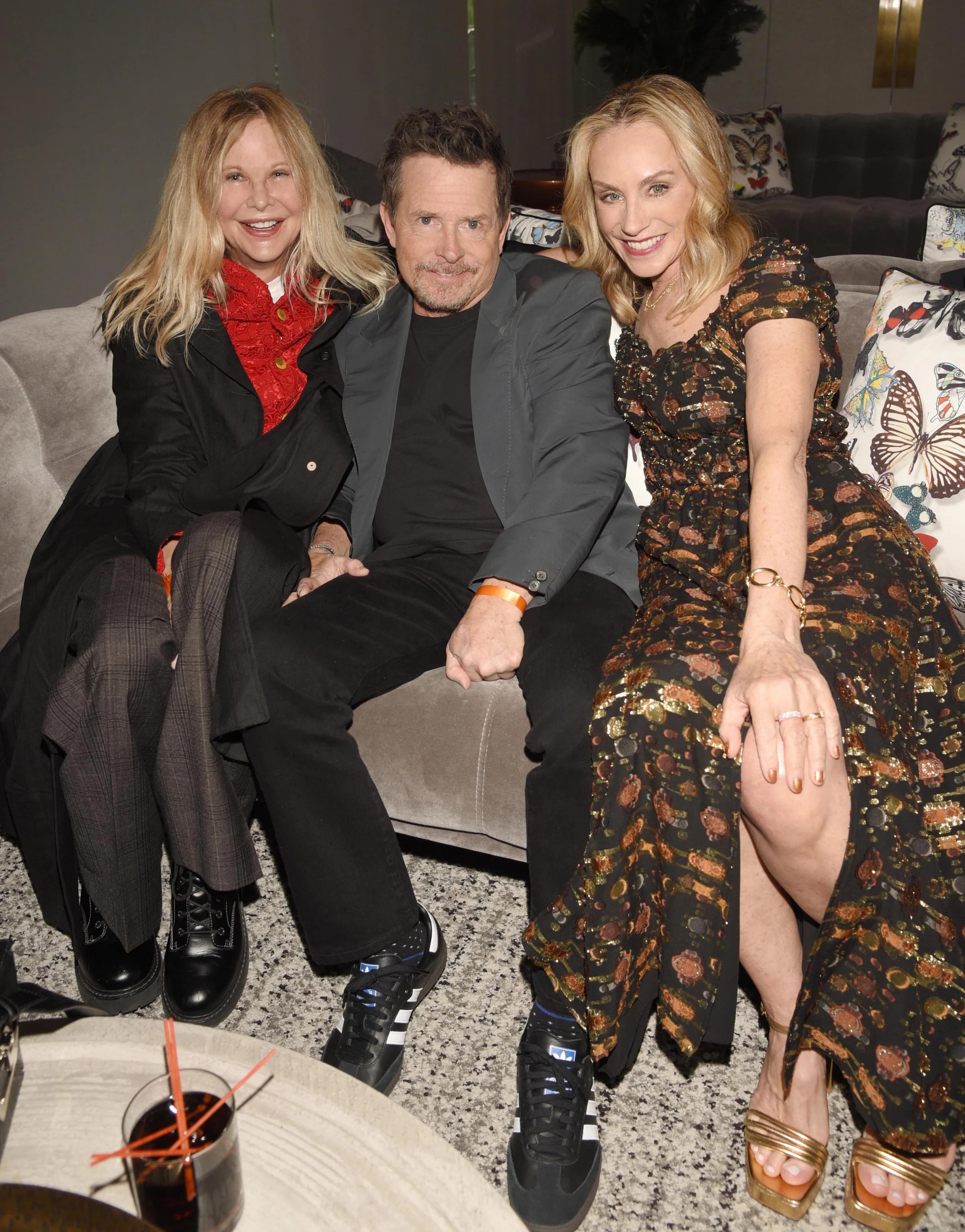 Meg Ryan smiling with Michael J. Fox and Tracy Pollan