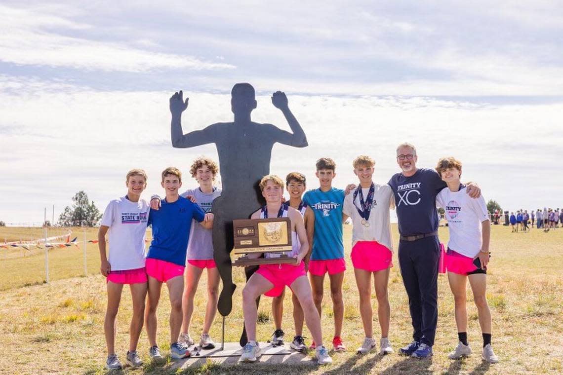 Trinity Academy senior Ian Carroll (holding trophy) helped recruit many of the runners who helped the Knights win their second straight team state title this past weekend. Josh Hobson/Courtesy