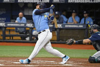 Seattle Mariners catcher Cal Raleigh, right, watches as Tampa Bay Rays designated hitter Harold Ramirez hits a two-run double off Seattle Mariners starter Bryce Miller during the first inning of a baseball game Sunday, Sept. 10, 2023, in St. Petersburg, Fla. (AP Photo/Steve Nesius)