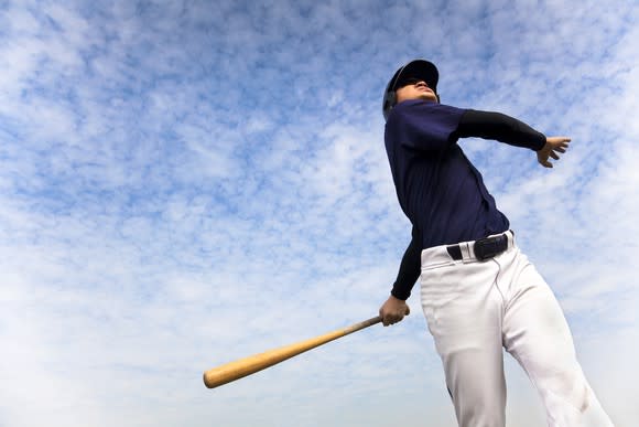 Baseball player completing swing
