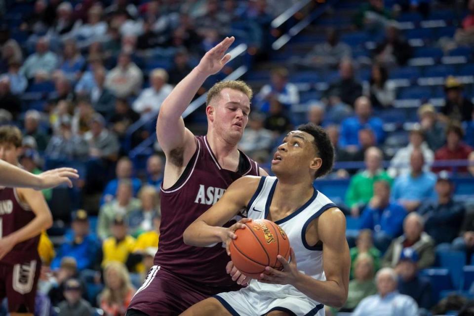 Warren Central’s Chappelle Whitney (21) looks for room to operate against Ashland Blazer’s Nate Freize. Whitney led the Dragons with 20 points and 10 rebounds.