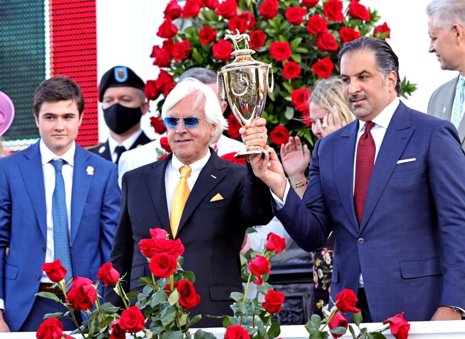 Medina Spirit owner Amr F. Zedan (right) and trainer Bob Baffert hold the trophy after winning the 147th running of the Kentucky Derby at Churchill Downs