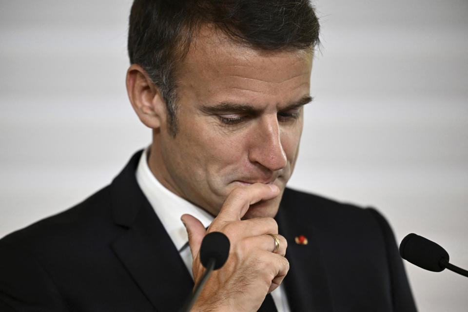 File - French President Emmanuel Macron reacts as he delivers his speech during the opening session of the the African Vaccine Manufacturing Accelerator conference, Thursday, June 20, 2024 in Paris. Emmanuel Macron once appeared as a bold, young leader offering to revive France through radical pro-business, pro-European policies so that voters have "no reason anymore" to vote for the extremes. Seven years after he was first elected, his call for snap elections weakens him at home and abroad, while it appears to propel the far right on the verge of power. (Dylan Martinez/Pool via AP, File)