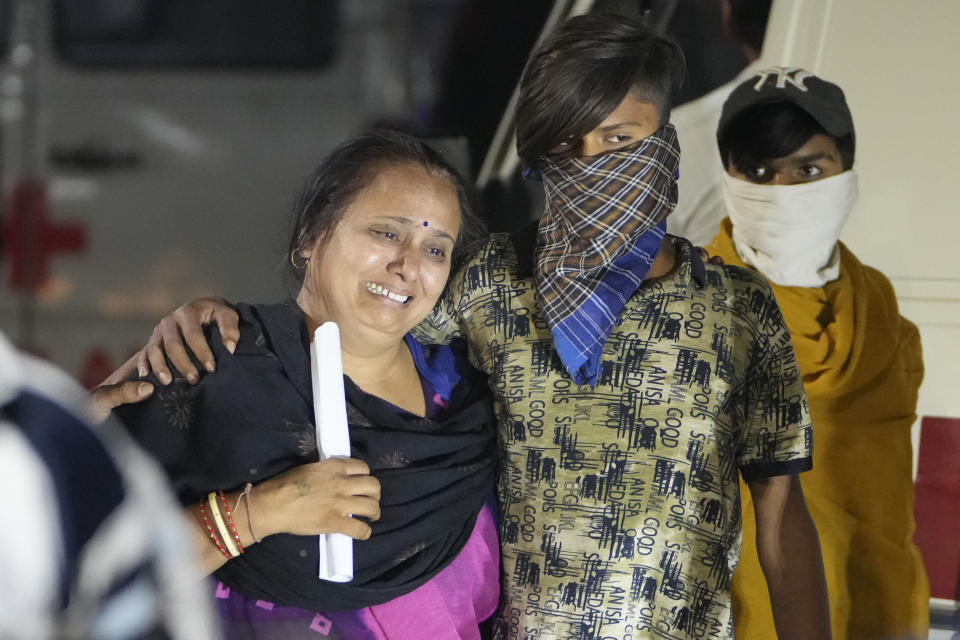 <p>Relatives of a victim mourn after a cable bridge across the Machchu river collapsed in Morbi town of western state Gujarat, India, Monday, Oct. 31, 2022. Dozens are dead and many are feared injured in the accident. (AP Photo/Ajit Solanki)</p> 