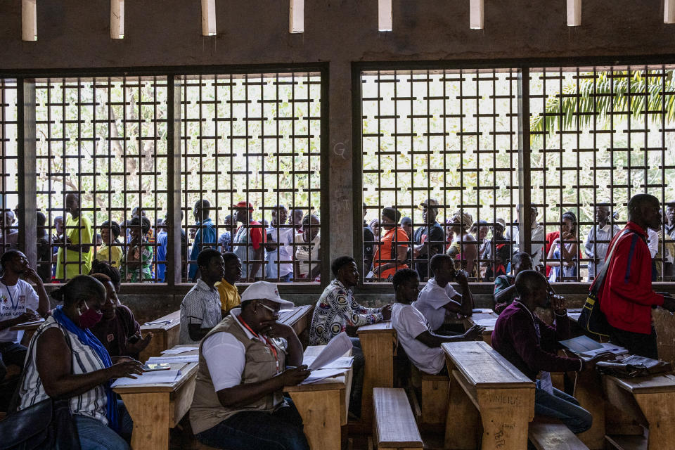 People line up to cast their votes for presidential and legislative elections outside the Lycee Boganda polling station in the capital Bangui, Central African Republic, Sunday, Dec. 27, 2020. President Faustin-Archange Touadera and his party said the vote will go ahead after government forces clashed with rebels in recent days and some opposition candidates pulled out of the race amid growing insecurity. (AP Photo)