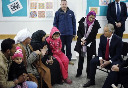 Quartet Representative to the Middle East and former British Prime Minister, Tony Blair (R), visits a UN-run school sheltering Palestinians, whose houses were destroyed by what they said was Israeli shelling during a 50-day war last summer, in Gaza City, February 15, 2015. REUTERS/Suhaib Salem