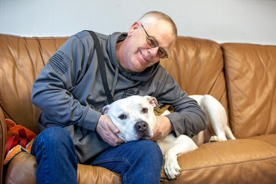 Paul Stinson of Springfield is a veteran who adopted Jax, a 3-year-old rescued pit bull who was trained to become his service dog by Shelley Raskin of Marlboro. Stinson sits with Jax at Cherry Lane Kennels in Howell, NJ Monday, March 25, 2024.