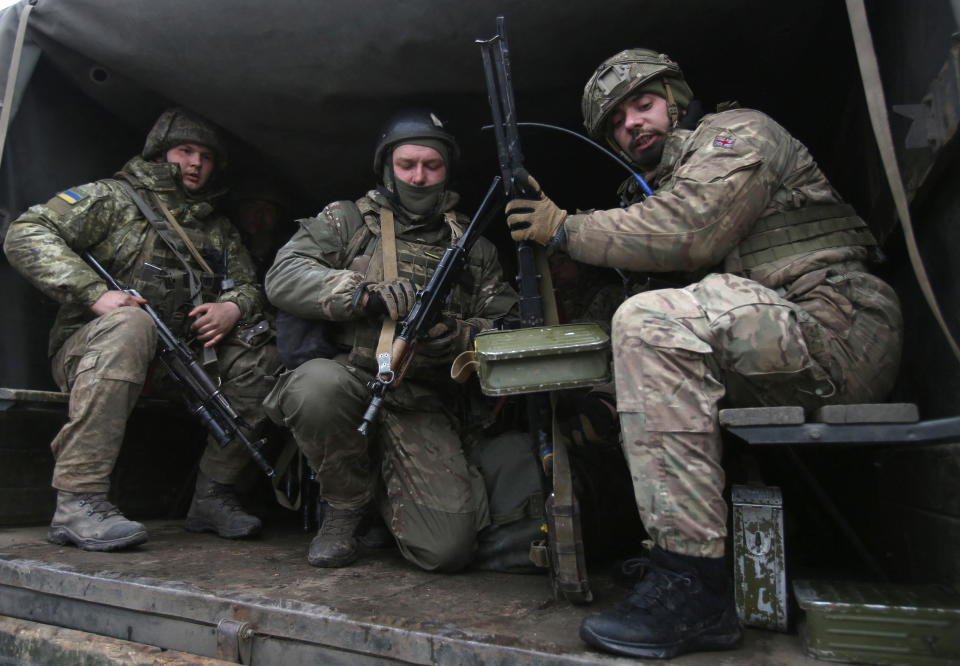 Servicemen of Ukrainian Military Forces move to their position prior to the battle with Russian troops and Russia-backed separatists in Lugansk region on March 8, 2022. - The number of refugees flooding across Ukraine's borders to escape towns devastated by shelling and air strikes passed two million, in Europe's fastest-growing refugee crisis since World War II, according to the United Nations. (Photo by Anatolii Stepanov / AFP) (Photo by ANATOLII STEPANOV/AFP via Getty Images)