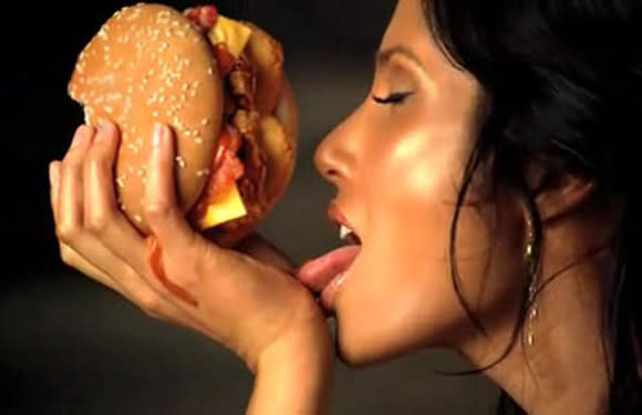 Foreplay on fast food? That's what Padma Lakshmi did in a burger ad. She raised eyebrows for using her sex appeal to sell junk food.  © Carl’s Jr.