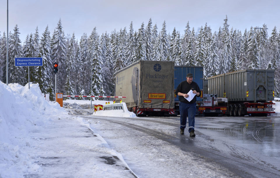 A truck driver with customs clearance documents walks towards the Norwegian Customs office at the Orje border crossing between Sweden and Norway, on Friday, Feb. 8 2019. Norway's hard border with the European Union is equipped with cameras, license-plate recognition systems and barriers directing traffic to Customs officers. Norway's membership in the European Economic Area (EEA) grants it access to the common market and most goods are exempt from paying duties but everything entering the country must be declared and cleared through customs. (AP Photo/David Keyton)