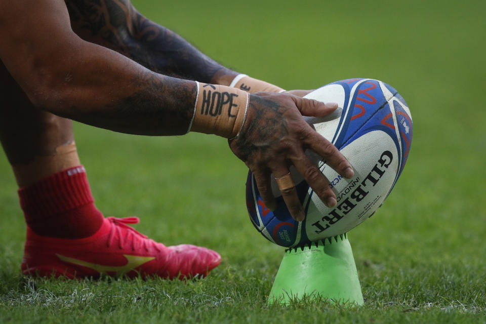 Tonga players warm up before the Rugby World Cup Pool B match between Tonga and Romania at the Stade Pierre Mauroy in Villeneuve-d'Ascq, outside Lille, France, Saturday, Oct. 8, 2023. (AP Photo/Michel Spingler)