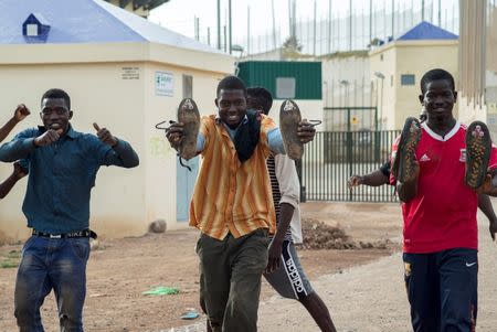 African migrants react as they arrive at the CETI, the short-stay immigrant centre, after crossing the border from Morocco to Spain's North African enclave of Melilla, Spain, June 26, 2016. REUTERS/Jesus Blasco de Avellaneda