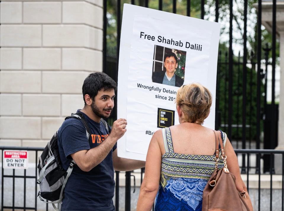 Darian Dalili speaks with a woman outside the White House  (Andrew Caballero-Reynolds / AFP via Getty Images file)