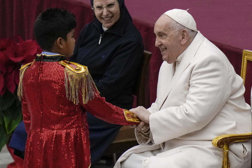 Pope Francis is greets a young performer as he celebrates his birthday with children assisted by the Santa Marta dispensary during an audience in the Paul VI Hall, at the Vatican, Sunday, Dec. 17, 2023. Pope Francis turnes 87 on Dec.17. (AP Photo/Alessandra Tarantino)