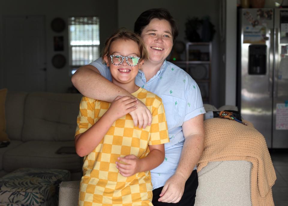 Logan Lauger, whose pronouns are they/them/their, poses with their wife’s son, Landon, 9, in their Sebastian home, Thursday, July 27, 2023. Lauger, 31, double-majored in psychology and sociology at Florida Atlantic University, and is a graduate student at Southern New Hampshire University working toward a master’s degree in clinical mental health counseling in hopes of launching a private mental health care practice for LGBTQ+ children and teens in Sebastian.