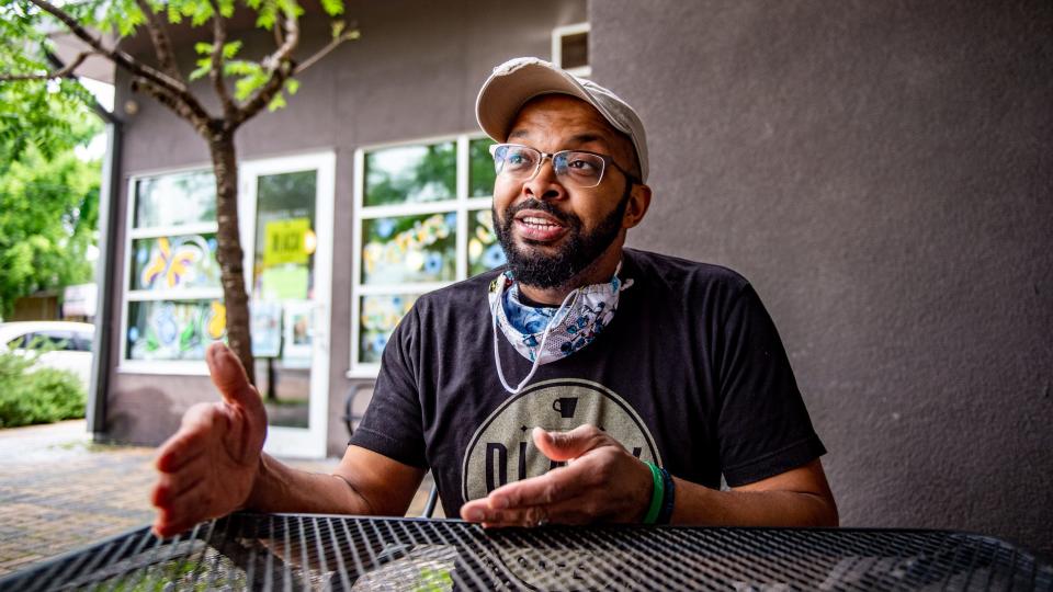 Trey Ware, the owner of Black Café, sits outside his business in downtown Lafayette. Ware said many of the hurdles Black business owners face stem from perception and the lack of financing options.