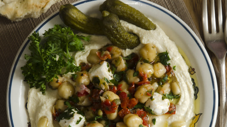 bowl of hummus with pickles