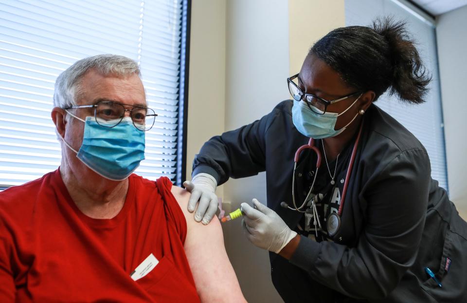 Medical assistant Laketa Johnson gives a flu shot to Randy Stover at Norton Healthcare Fincastle in downtown Louisville Wednesday afternoon. Sept. 16, 2020