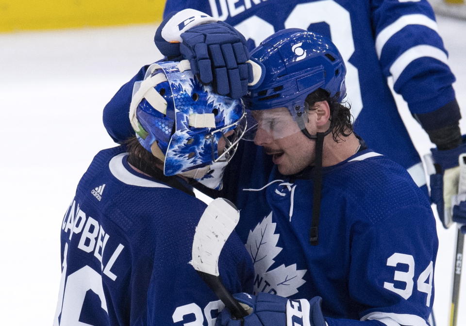 Toronto Maple Leafs center Auston Matthews (34) and goaltender Jack Campbell (36) congratulate each other after the team's win over the Edmonton Oilers in overtime in an NHL hockey game in Toronto, Saturday, March 27, 2021. (Frank Gunn/The Canadian Press via AP)