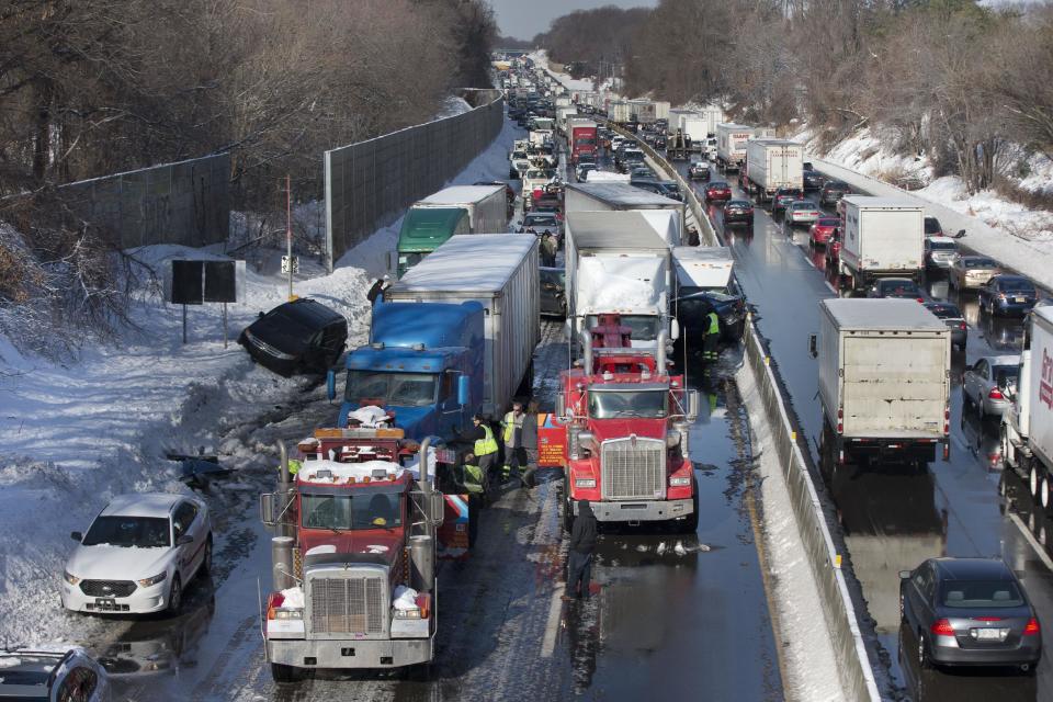 Vehicles are piled up in an accident Friday, Feb. 14, 2014, in Bensalem, Pa. Traffic accidents involving multiple tractor trailers and dozens of cars have completely blocked one side of the Pennsylvania Turnpike outside Philadelphia and caused some injuries. (AP Photo/Matt Rourke)