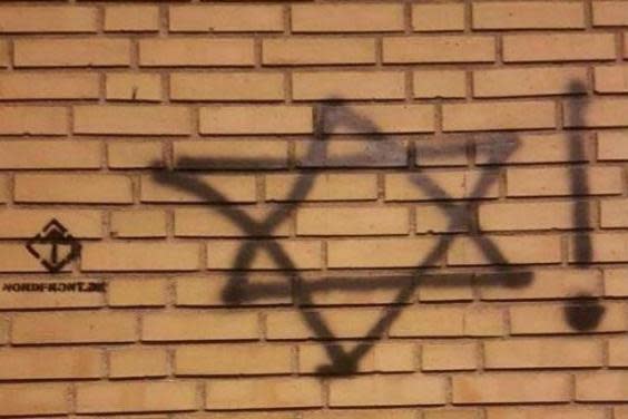 A symbol for neo-Nazi group Nordfront can be seen next to antisemitic graffiti (Jewish Society in Denmark)