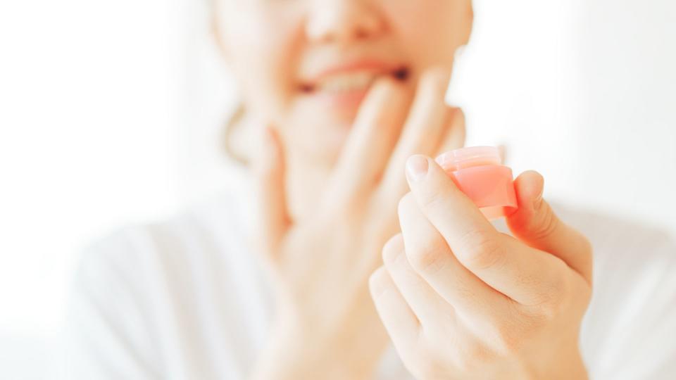 woman applying lip balm