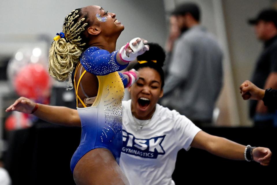 Fisk University gymnast Alyssa Wiggins, left, celebrates after finishing her routine on the uneven bars during the Tennessee Collegiate Classic meet in Lebanon, Tenn., Friday, Jan. 20, 2023. Fisk is the first historically Black university to have an intercollegiate women’s gymnastics team.