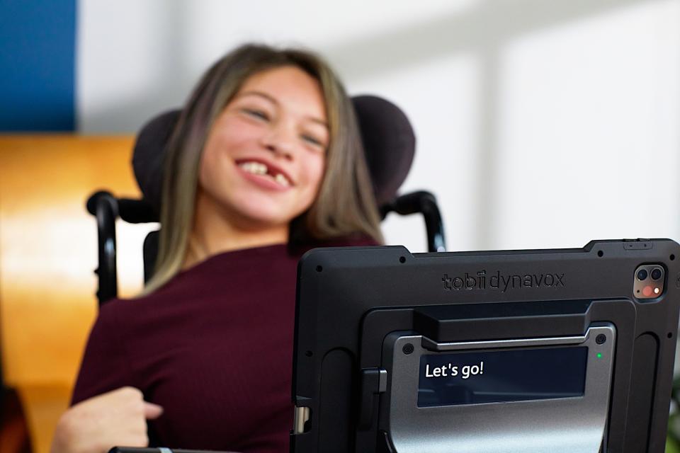 <p>A Tobii Dynavox's user with a TD Pilot attached to her wheelchair.</p>
